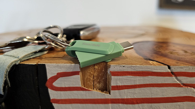 A SanDisk flash drive on a keychain.