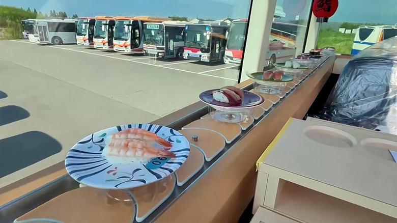 Sushi on conveyor belts delivered on the top floor of a double-decker bus